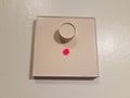 White dimmer on wall with red light