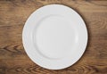 White dinner plate on wooden table top view Royalty Free Stock Photo