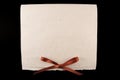 White diploma with red ribbon