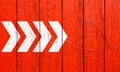 White directional arrow signs pointing direction left to right painted on a red wood wall signboard texture background banner