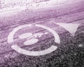 White directional bicycle symbol on cycle path covered in winter in pink light Royalty Free Stock Photo