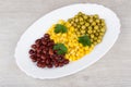 White dish with green peas, beans, sweet corn and parsley Royalty Free Stock Photo