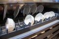 White dishes on the contemporary plastic shelves in the kitchen cupboard