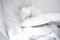 White dishes at white fabric as a background Royalty Free Stock Photo