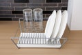 White dishes drying on metal dish rack Royalty Free Stock Photo