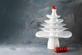 White dishes Pyramid of Christmas tree shape with red tomato on top and bunch below on dark. Creative concept, dishware, veg, Royalty Free Stock Photo