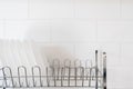 White dishes after washing in special drainer Royalty Free Stock Photo