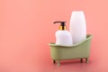 White dispenser bottle in green bathroom. Cosmetic packaging with pump for shampoo, shave foam or body shower gel. Liquid soap Royalty Free Stock Photo