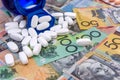 White disperced pills on colorful australian dollars Royalty Free Stock Photo