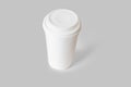 White Disposable paper Coffee cup with lid and round coaster mockup isolated on a grey background Royalty Free Stock Photo