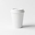 A white disposable paper cup with a plastic lid is centered against a white Royalty Free Stock Photo