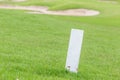 The white distance marker pole to inform range of golfing with b Royalty Free Stock Photo