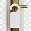 A white do not disturb sign attached to a brass-colored door handle on a door Royalty Free Stock Photo