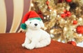 White dog doll wearing santa hat with christmas tree Royalty Free Stock Photo