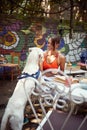 White dog standing on two legs, leaned on his female owner