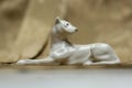 White dog statue on a gold beige neutral background Royalty Free Stock Photo