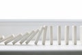 White domino, domino principle, on white background Royalty Free Stock Photo