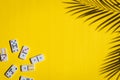 White dominoes with colorful dots and a round spinning board on a yellow background. Board game. Royalty Free Stock Photo