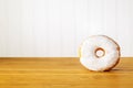 White donut on a wooden table