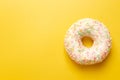 White donut on yellow background top view copy space Royalty Free Stock Photo