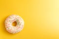 White donut on yellow background top view copy space Royalty Free Stock Photo