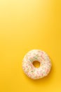 White donut on yellow background top view copy space Royalty Free Stock Photo