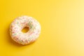 White donut on yellow background top view copy space Royalty Free Stock Photo