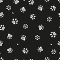 White doodle paw prints with hearts and black background seamless fabric design pattern Royalty Free Stock Photo