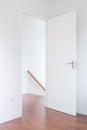 White door, wood floor to down stair in modern home, minimalist style Royalty Free Stock Photo