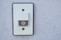 White Doorbell Button with Music Note Icon on Gray Wall Royalty Free Stock Photo