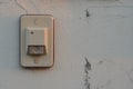 White doorbell on the old wall of the house