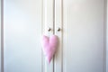 White doors of cupboard and pink decoration heart. retro wooden design background texture