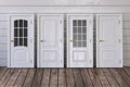 White doors of different types on white wooden background Royalty Free Stock Photo
