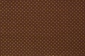 White dots over brown fabric background and texture. Royalty Free Stock Photo