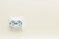 White double electrical outlet on a beige wall Royalty Free Stock Photo