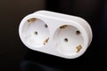 White double socket on black wooden table Royalty Free Stock Photo