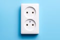 White double socket isolated on blue background. Electric lighting Royalty Free Stock Photo