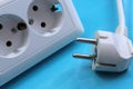 White double socket and plug on blue background Royalty Free Stock Photo