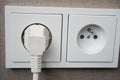 White double socket with a plug inserted, concept of electrical safety, home protection, secure wiring Royalty Free Stock Photo
