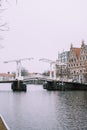 White drawbridge over the water of the river in Haarlem, Netherlands. Typical Holland cityscape.