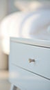 A white drawer with a silver handle on it, AI