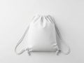 A white drawstring backpack with white cords and toggles on a white background Royalty Free Stock Photo
