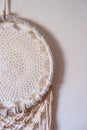 White dreamcatcher hanging on a white wall. Boho interior decor Royalty Free Stock Photo
