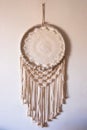 White dreamcatcher hanging on a white wall. Boho interior decor Royalty Free Stock Photo