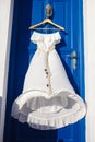 White dress on blue door in greek house Royalty Free Stock Photo