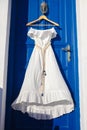 White dress on blue door in greek house Royalty Free Stock Photo