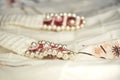 White dress with decorative details, embroideries, buttons and bisser, close-up. The concept of beauty, style and fashion. Royalty Free Stock Photo