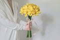 White dress woman holding yellow lily flower bouquet Royalty Free Stock Photo