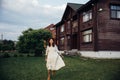 White dressed dark haired woman enjoing on lavender field on the country house background