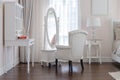 white dressing table with classic chair aand elegance mirror in